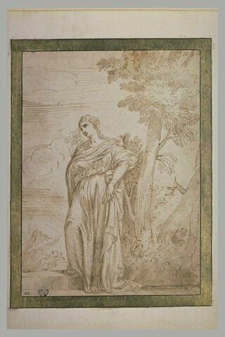 Une femme, debout au pied d'un arbre, tenant une croix dans la main droite, image 2/2