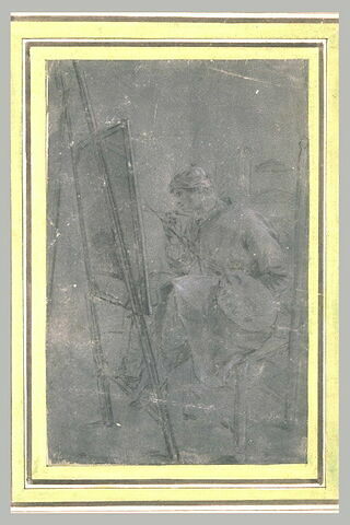 Un peintre assis et peignant un tableau placé sur un chevalet, image 2/2