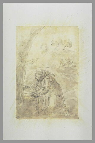 Saint François d'Assise agenouillé à l'entrée d'une grotte