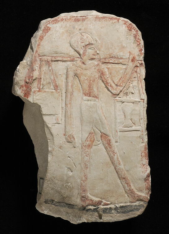 relief depicting a man bearing a shoulder pole