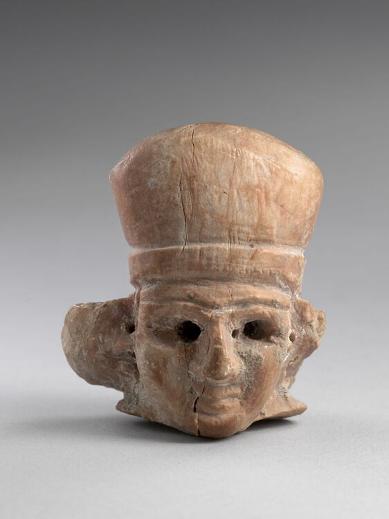 Head of a woman wearing a polos crown