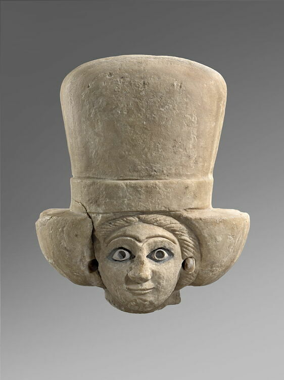 Head of a woman wearing a polos crown