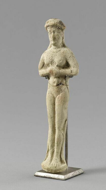 Molded statuette of a naken woman wearing a baldrick, hands pressed together