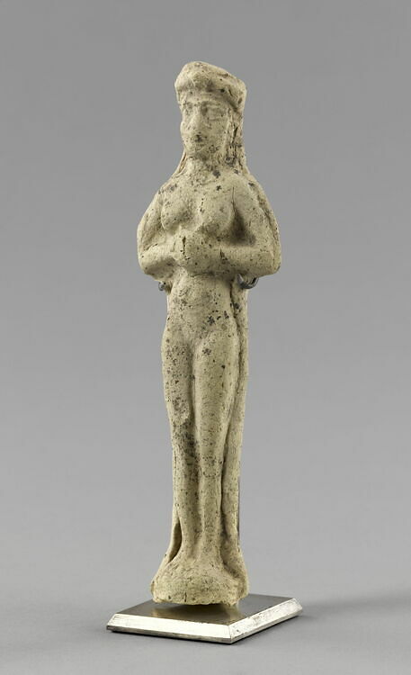 Molded statuette of a naken woman wearing a baldrick, hands pressed together