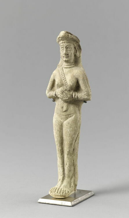 Molded statuette of a naken woman wearing a baldrick, hands pressed together