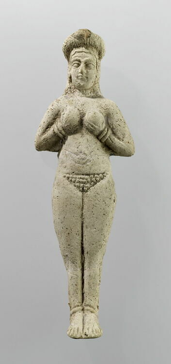Moulded figurine. Naked woman, hands maintaining breasts. Susa.