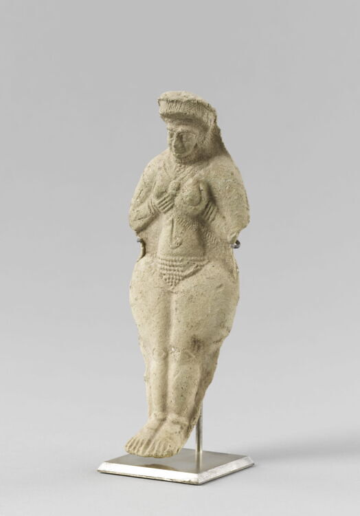 Molded statuette of a naken woman cupping her breasts