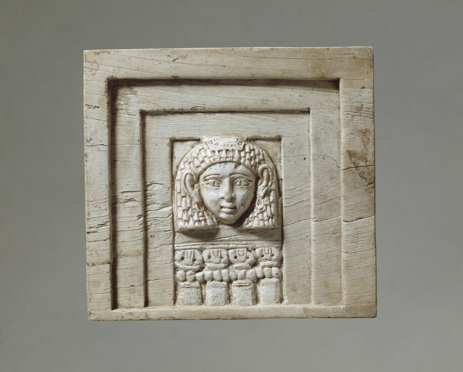Plaque: woman looking through a window