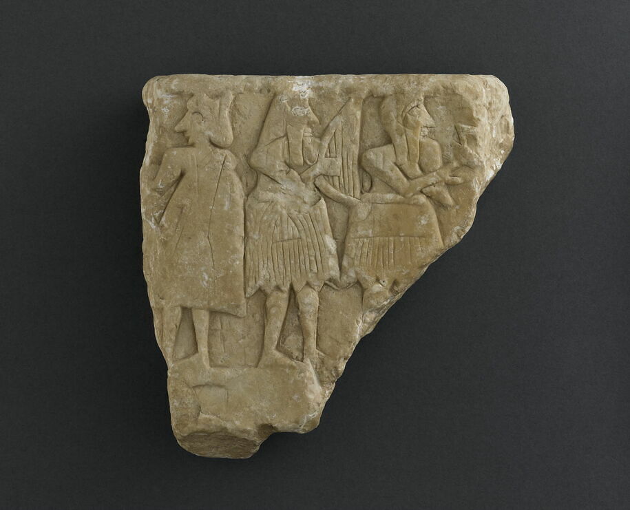 Fragment of votive bas-relief: banquet with musicians
