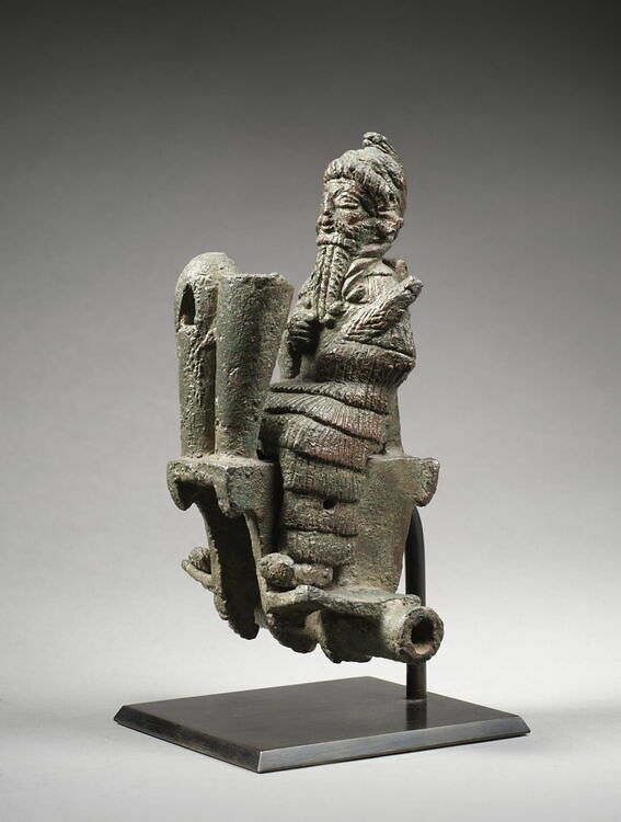 Biker god mounted on a chariot, his head covered with a serpent.