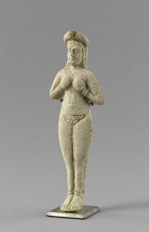 Molded statuette of a naken woman cupping her breasts