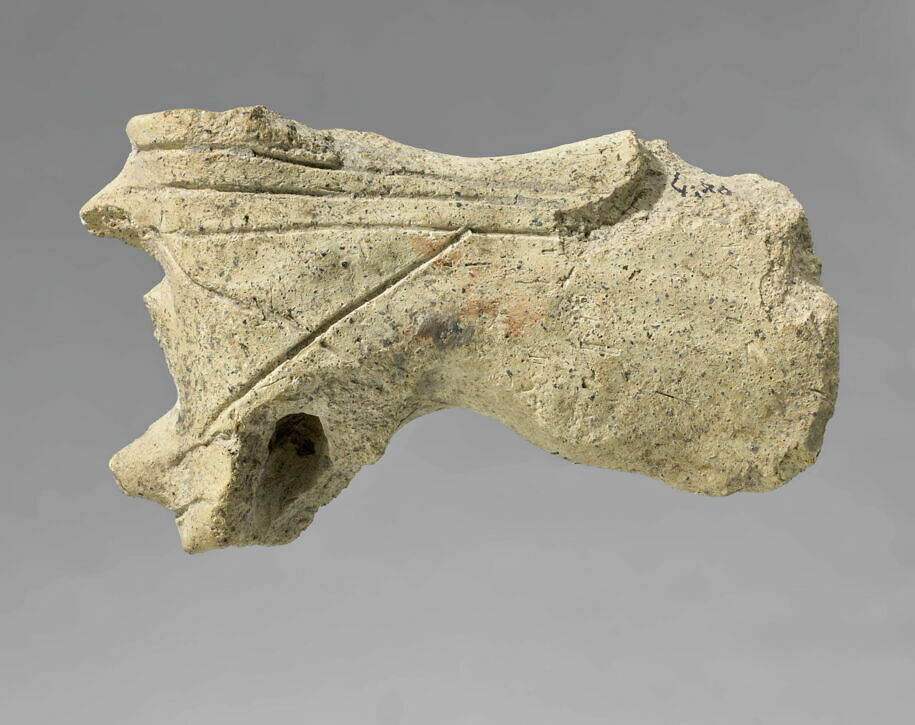 Model of an axe with three protuberations. From Susa.