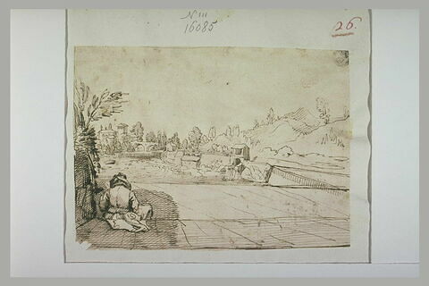 Homme assis, de dos, face à un barrage, près d'une ville, image 1/1