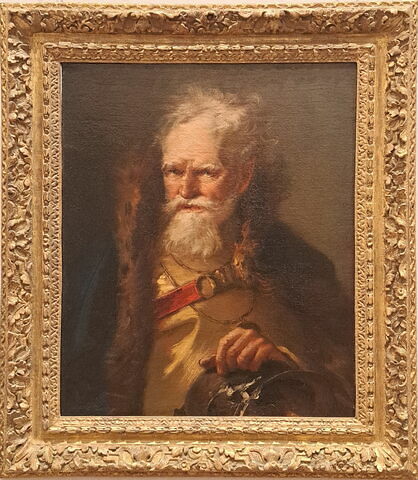 Portrait d'homme barbu âgé, la main posée sur une pièce d'armure
