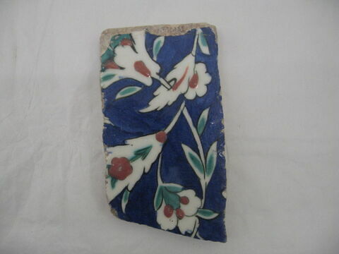 Fragment de carreau de bordure au rinceau de feuilles hançeri, palmettes et feuilles composites sur fond cobalt