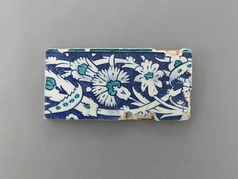Carreau d'un bandeau à rinceaux portant des oeillets et des fleurs composites, image 1/1