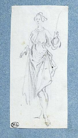 Une femme, debout, une verge dans la main gauche, image 1/2
