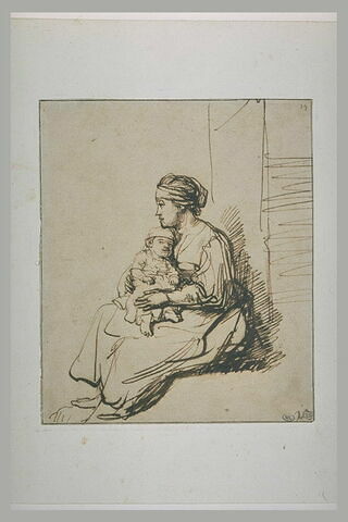 Jeune femme assise tenant son enfant sur ses genoux, image 2/2