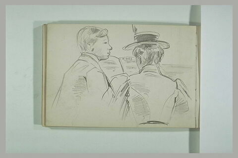 Une femme, de dos, et un jeune homme, devant une partition de Debussy, image 2/2