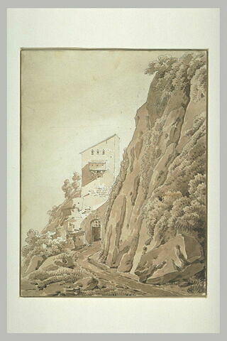 Chemin et maison sur le versant d'un rocher escarpé