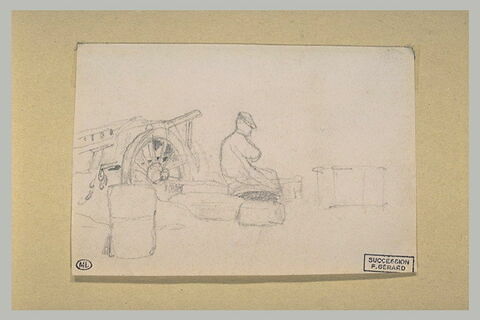 Homme assis sur une pierre, près d'une charrette, image 1/1