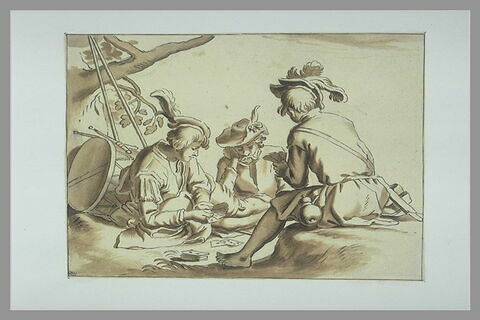 Trois soldats assis à terre et jouant aux cartes