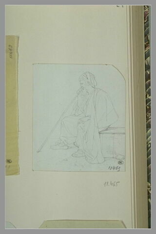 Oriental, coiffé d'un turban, assis sur une pierre, image 1/1