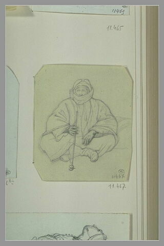 Oriental fumant, coiffé d'un turban et assis sur le sol, image 1/1