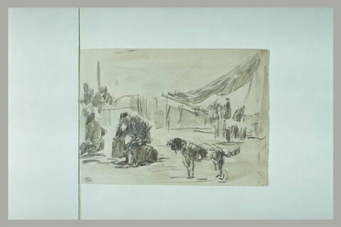 Homme assis avec un chien auprès de lui, image 1/1