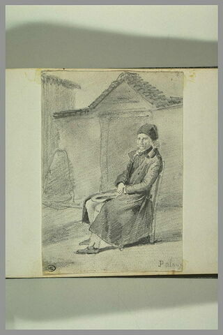 Vieil homme assis dans un fauteuil devant une porte, image 2/2