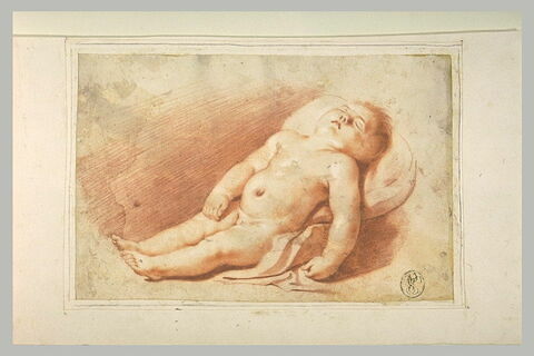 Jeune enfant nu, couché sur des coussins, image 1/1