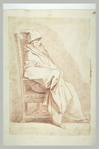 Homme barbu, coiffé d'un bonnet, assis dans un fauteuil, de profil, image 2/2