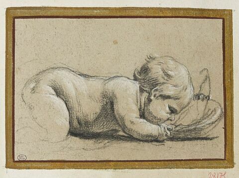 Enfant nu couché sur le ventre, buvant dans une écuelle