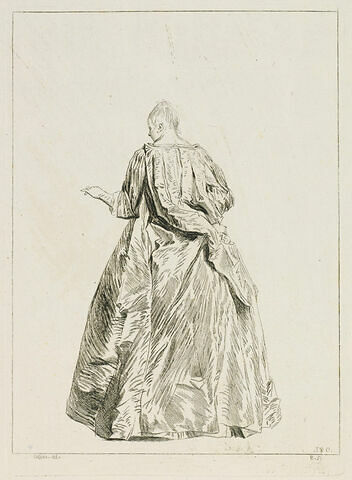 Femme debout, vue de dos, tendant la main gauche