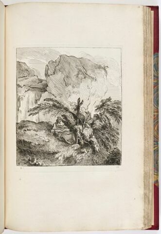 Solitaire lisant au pied d'une croix au milieu de rochers, image 1/1