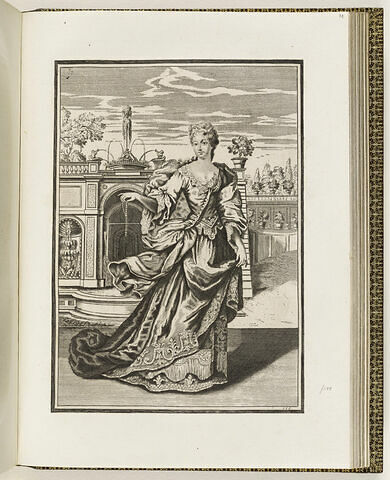 Une femme debout devant une fontaine, portant un collier de perles dans sa main, image 1/1