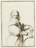 Un vieil homme debout, mesurant un globe avec un compas, image 1/2